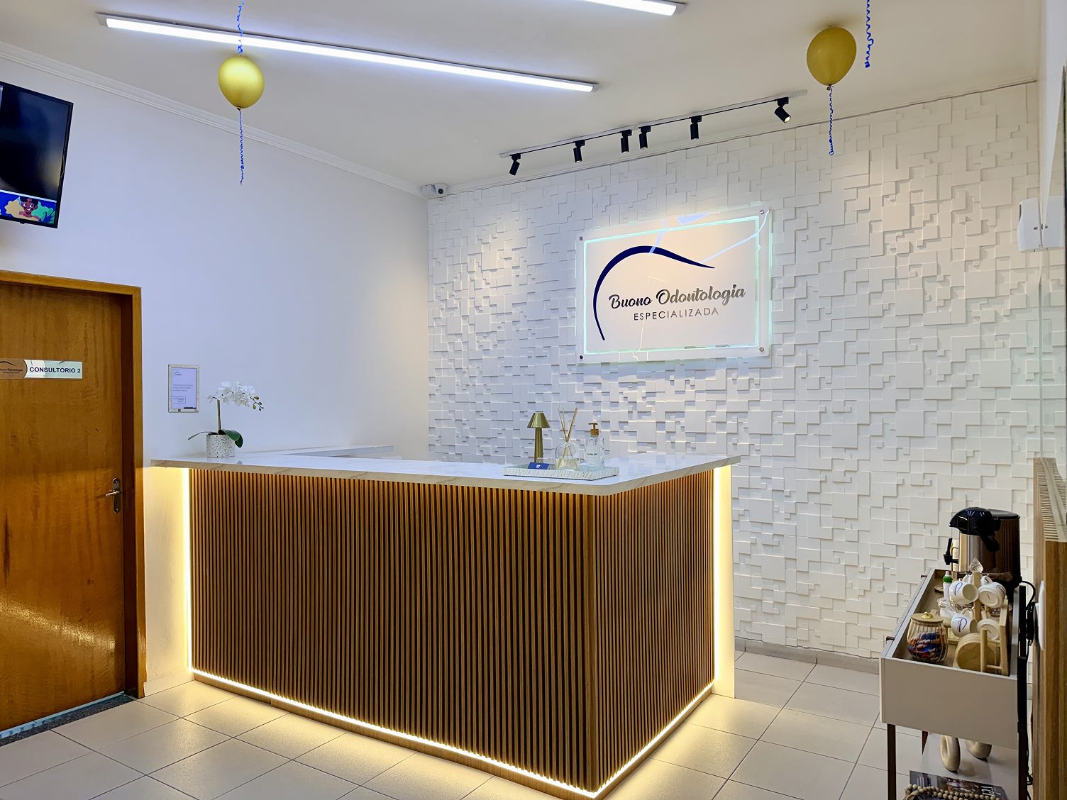 Recepção da Buono Odontologia com balcão de madeira e cafezinho